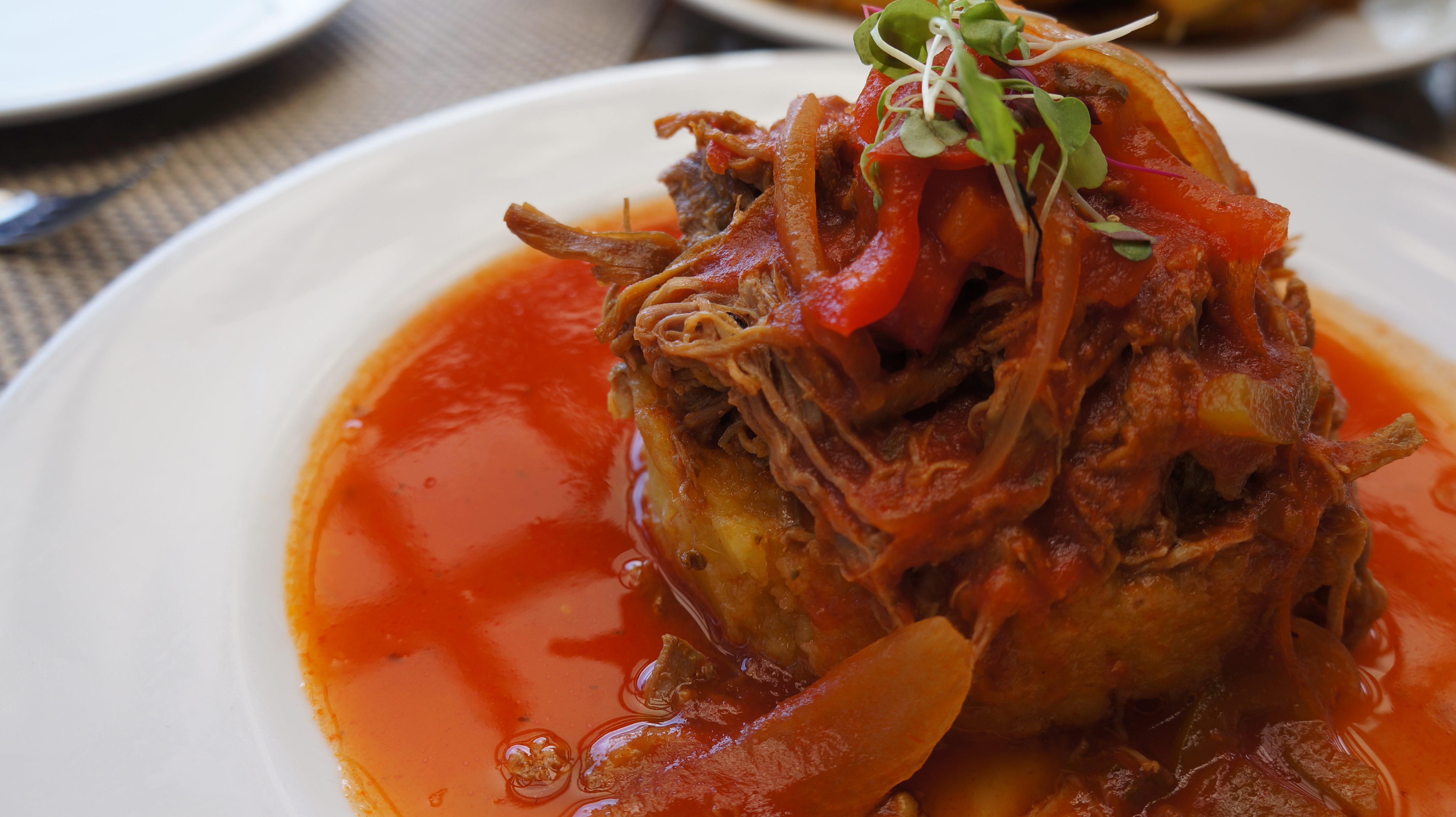 Mofongo covered in a tomato based sauce